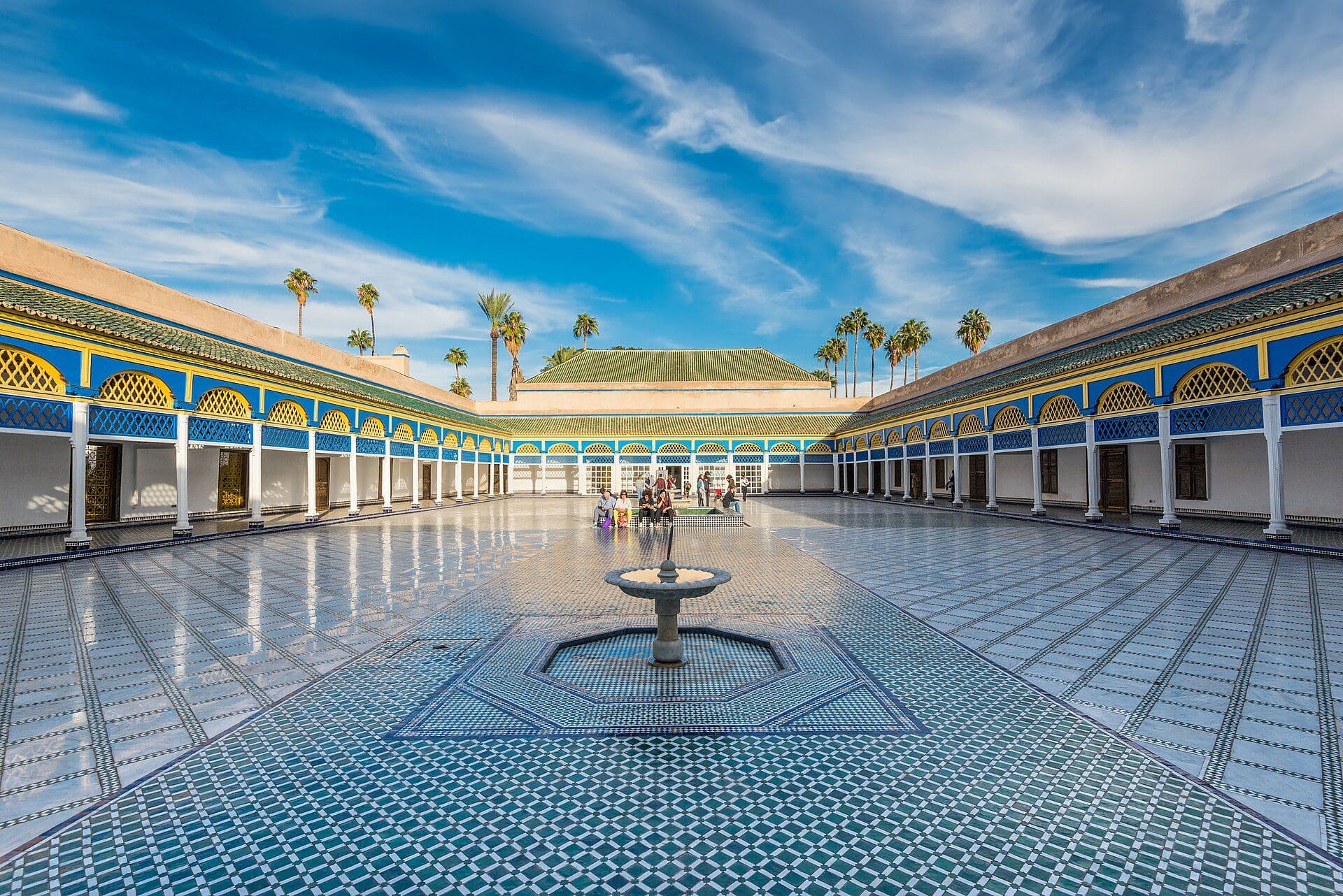Courtyard of the Bahia Palace in Marrakesh with zellige tiles and palm trees